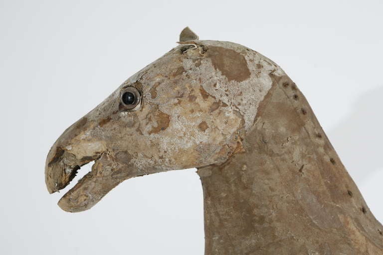 A toy horse with a horsehair tail and glass eyes.