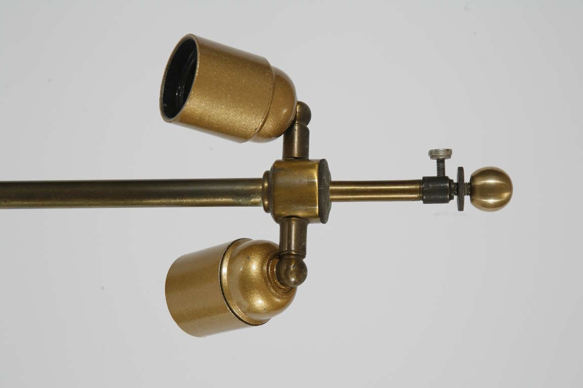 A pair of brass and bronze table lamp columns with two bulb fixtures each. Column is a 3