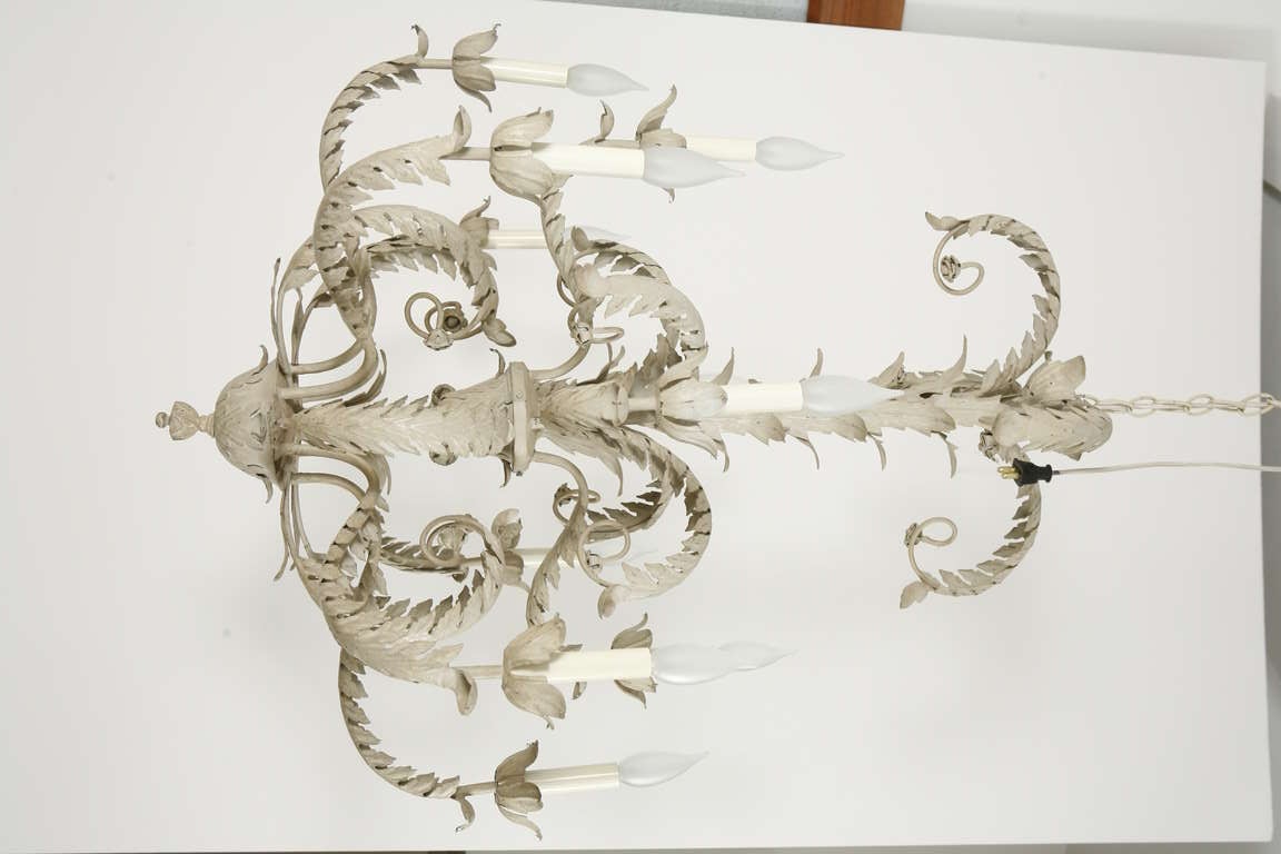 A pair of white painted two tier tole metal chandeliers. Price listed per item. Pair available at $9,500 for the pair.