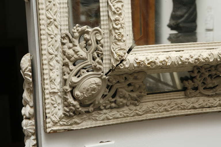 A white painted metal mirror in the Dutch style.