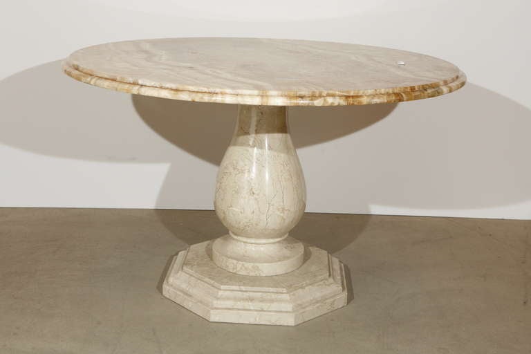 A round gueridon table with a carved and polished marble base and an intricately patterned, mirror-matched round onyx top

French, circa 1860