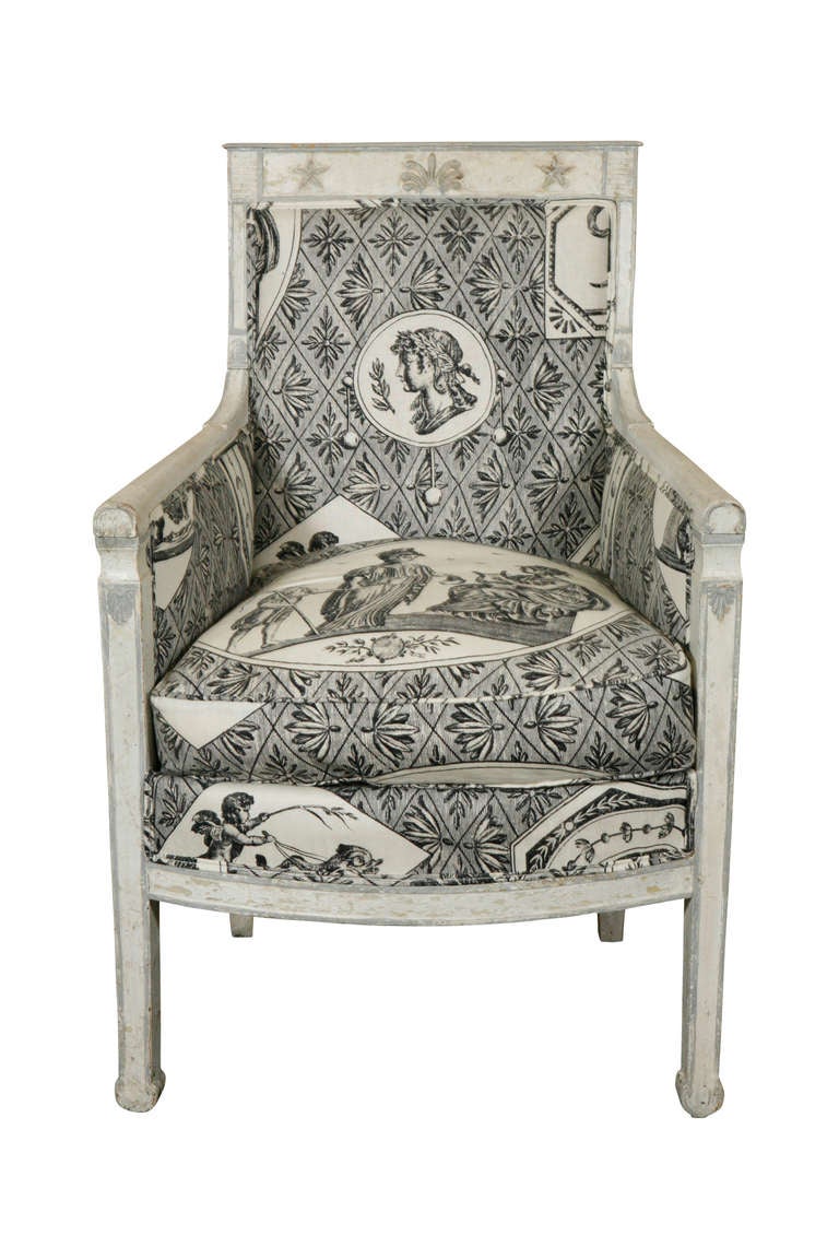 A white painted consulat bergere upholstered in a classic toile.