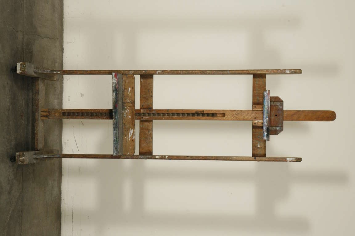 A wooden artist's easel from mid-century. Adjustable and made for small and large canvas format paintings.