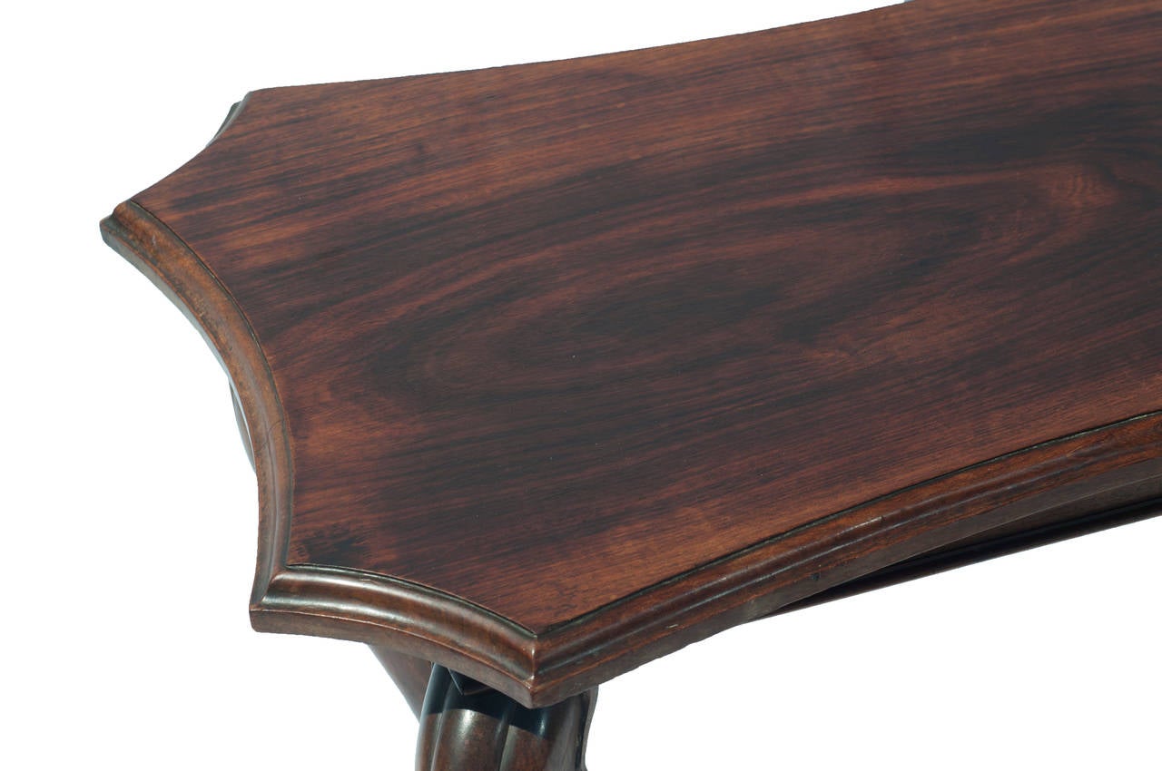 A colonial mahogany side table with claw feet.