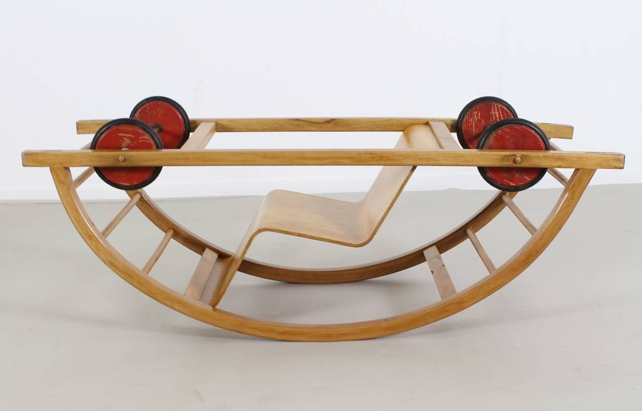 Typical 1950s children rock and rolling chair.
Designer: Hans Brockhage and Erwin Andra.
Manufacturer: Siegfried Lenz, Germany.
Plywood seating with wooden wheels.

