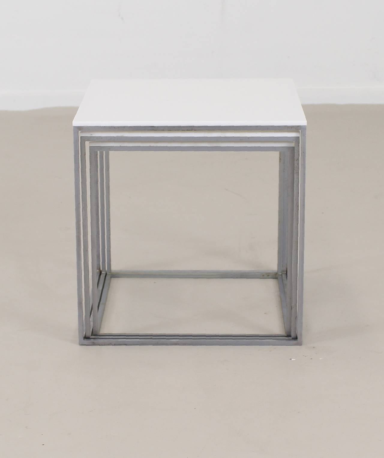 Well-known iconic designed original set of nesting tables.
Designer: Poul Kjaerholm, 1957.
Manufacturer: Kold Christensen.
Steel frames with acrylic tops.
Stamped Denmark.

Parcel Express shipping advised.