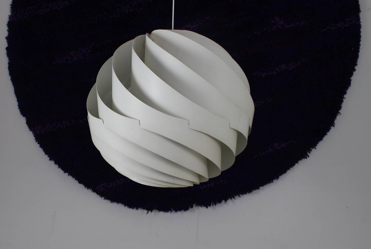 Huge iconic pendant lamp.
Designer: Louis Weisdorf, 1965.
Manufacturer: Lyfa, Denmark.
Model: Turbo II.
White metal strips.
Measure: 60cm diameter.

Standard parcel shipment is advised.