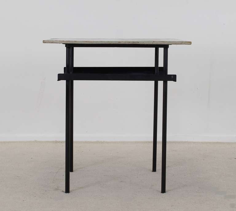 Small side table by Wim Rietveld and Andre Cordemeijer for  Auping Holland

The top is made of multiplex wood, light grey color ( larger wear on top)
Black metal frame with a magazine shelf in perforated metal

Typical Dutch Industrial