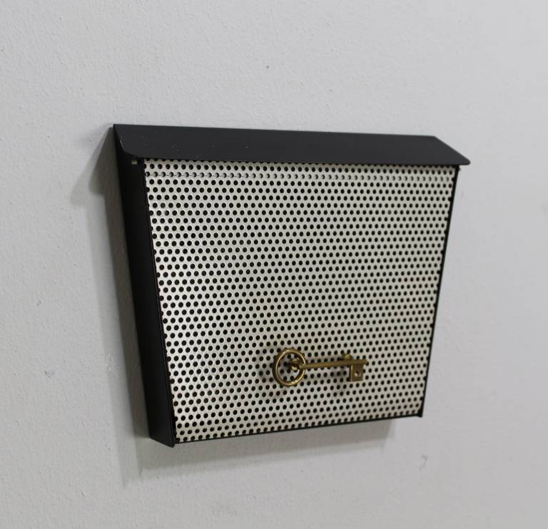 Nice small wall cabinet to store the house and car keys
German design and manufacturing

Perforated white metal flap door

Express parcel shipment advised