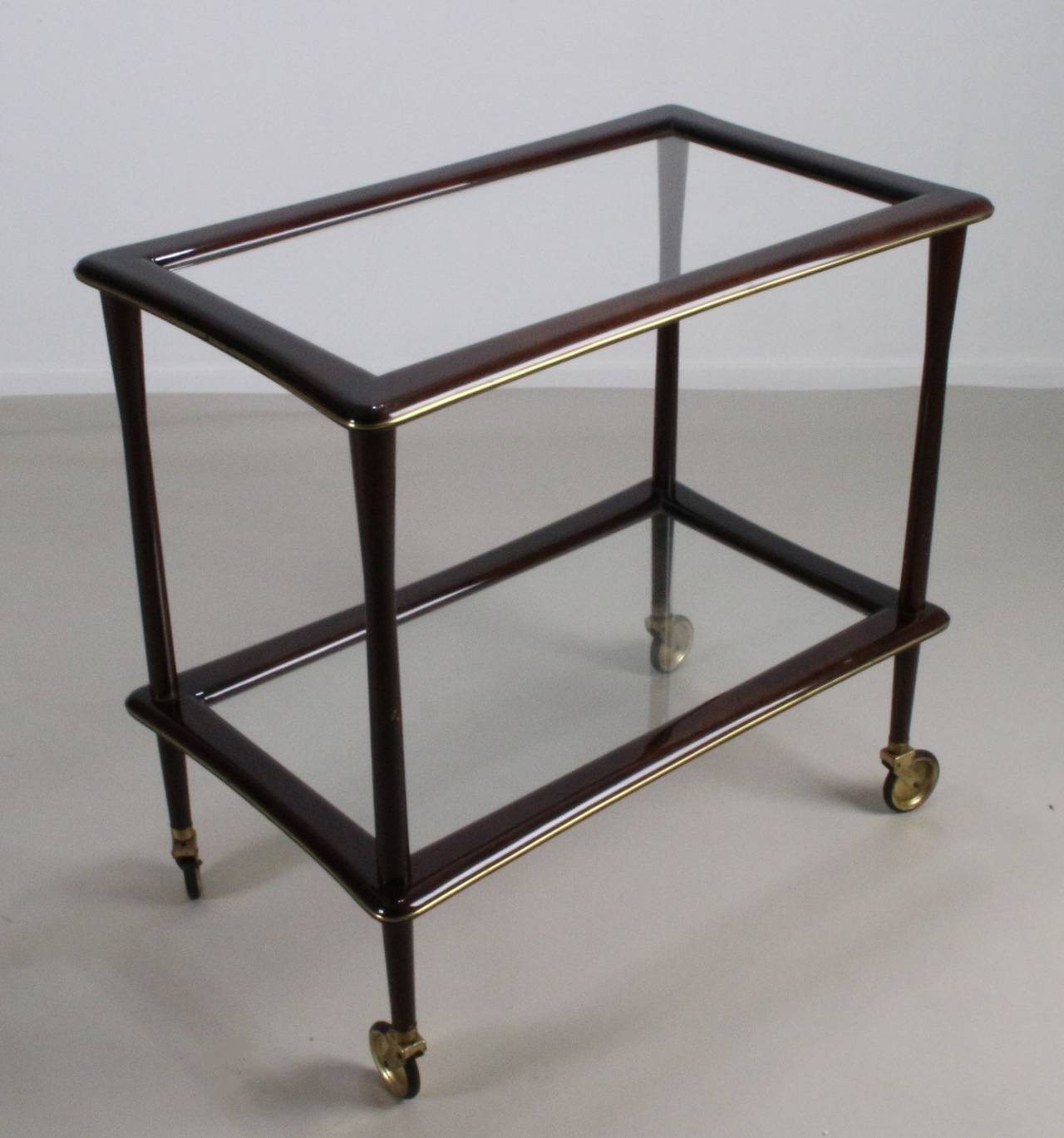 Nice Italian cart tea trolley. 
Lacquered brown wood with glass.
Very elegant curved sides of the glass.
Nicely shaped legs.
 