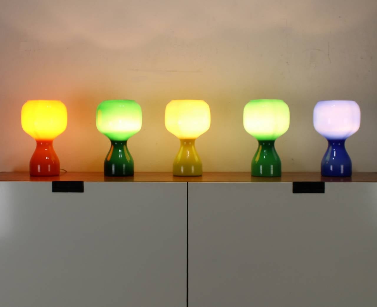 Colorful set of table lamps
Designer: Jean-Paul Emonds-Alt 1965
Manufacturer: Philips Belgium 
Opaline glass in different colors
Two tones of green

Express parcel shipment is advised