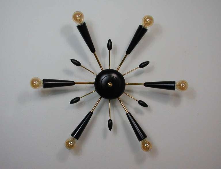 Awesome 1950s Italian 6 light Flush Mount or Wall Lamp. Made of black lacquered wood & brass.
The lamp works on 220V as well as 110V and requires 6 E14 Edison screw on bulbs (we used gilt bulbs for the photos which looks very pretty).
Diameter is