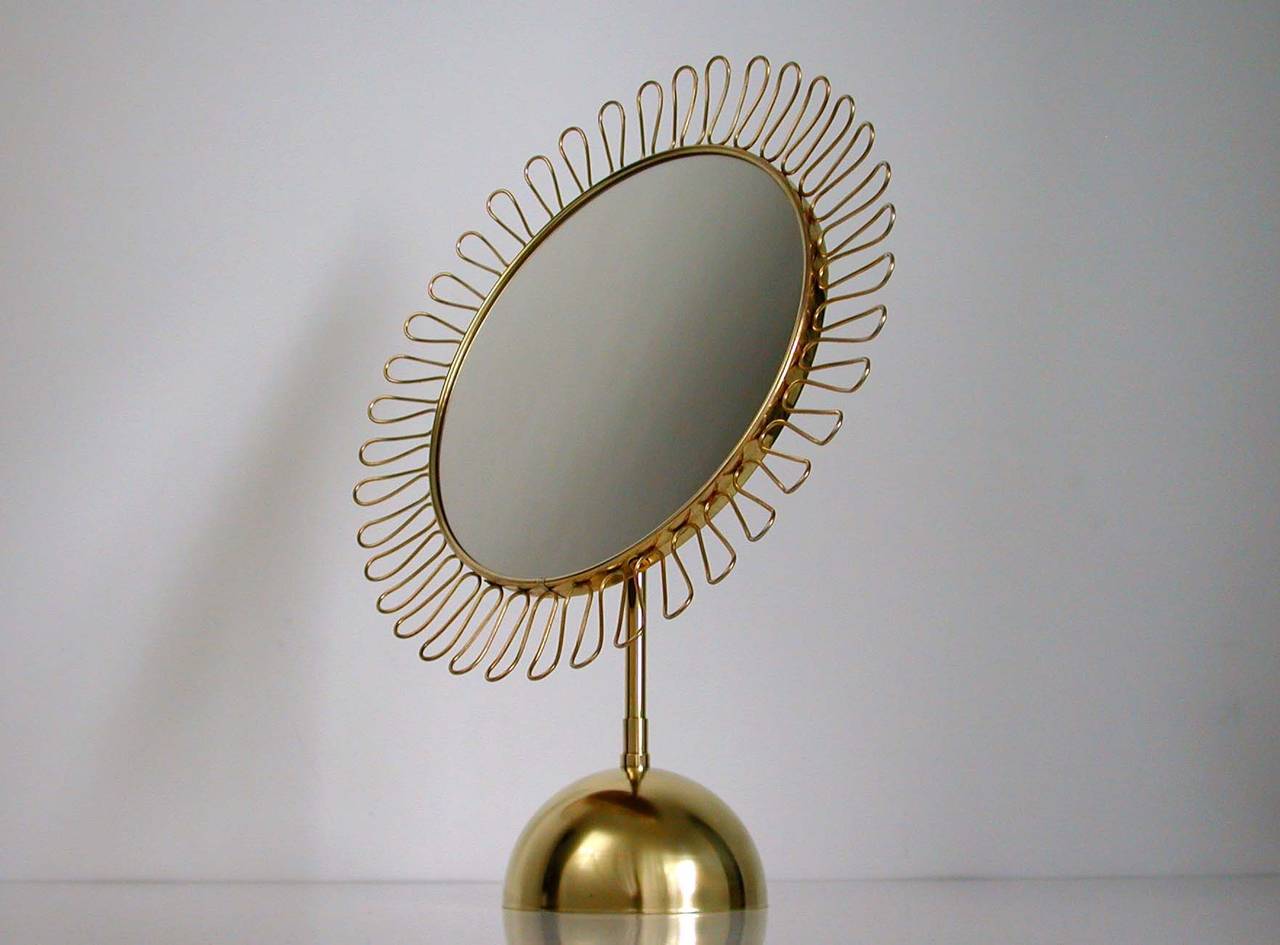 Beautiful sculptural brass loop table mirror with adjustable mirror and wooden rear in the manner of Josef Frank for Svenskt Tenn, Sweden 1950s.