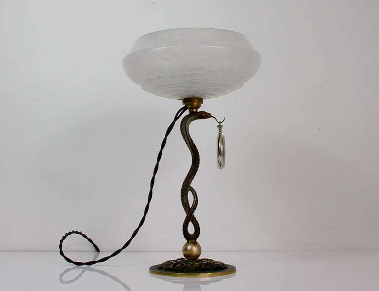 Awesome 1930s French Art Deco Bronze Serpent Cobra Pocket Watch Table Lamp Combo with white mottled lamp shade.
The lamp has been rewired with black fabric cord. It has got a French B22 bayonett socket and works on 220V as well as 110V.
It has hot