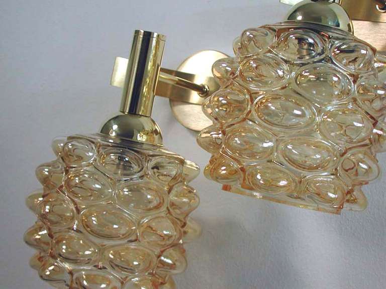 Beautiful pair of 1960s French wall lamps. The lamps have got amber bubble glass lamp shades and brass fixtures.
They have got B22 French sockets and work on 110 V as well as 220 V.
