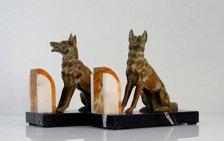 Awesome pair French bookends on three tone marble bases featuring German shepherd dogs.
Marble bases professionally polished with no chips or cracks. Some minor wear to the coloring of the dogs.