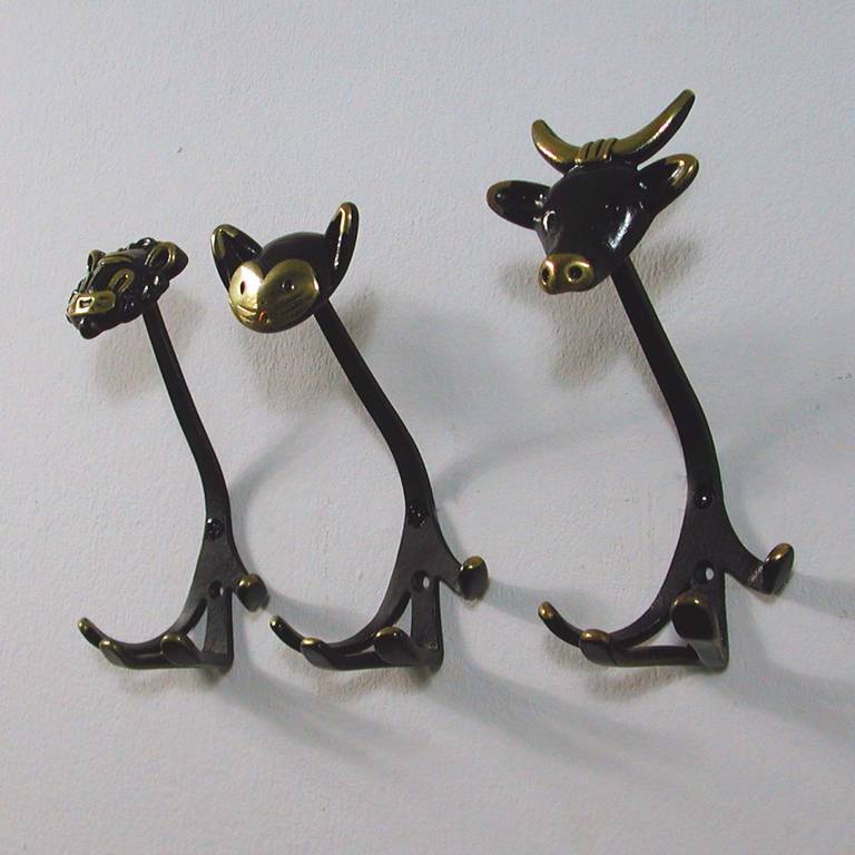 Awesome set of three Walter Bosse Vienna bronze and partly patinated coat or wall hooks. Made in Austria in the 1950s. Marked 