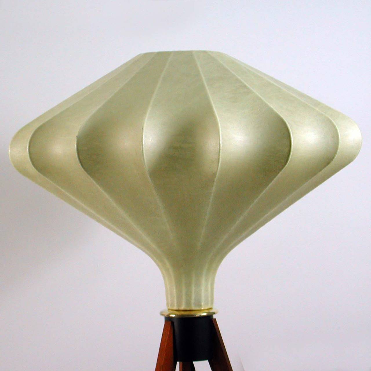 Beautiful Danish modern floor lamp on teak tripod foot with fiber glass cocoon diamond shaped lamp shade in the Style of Acille Castiglioni.

Excellent condition. Rewired with new fabric wiring.
