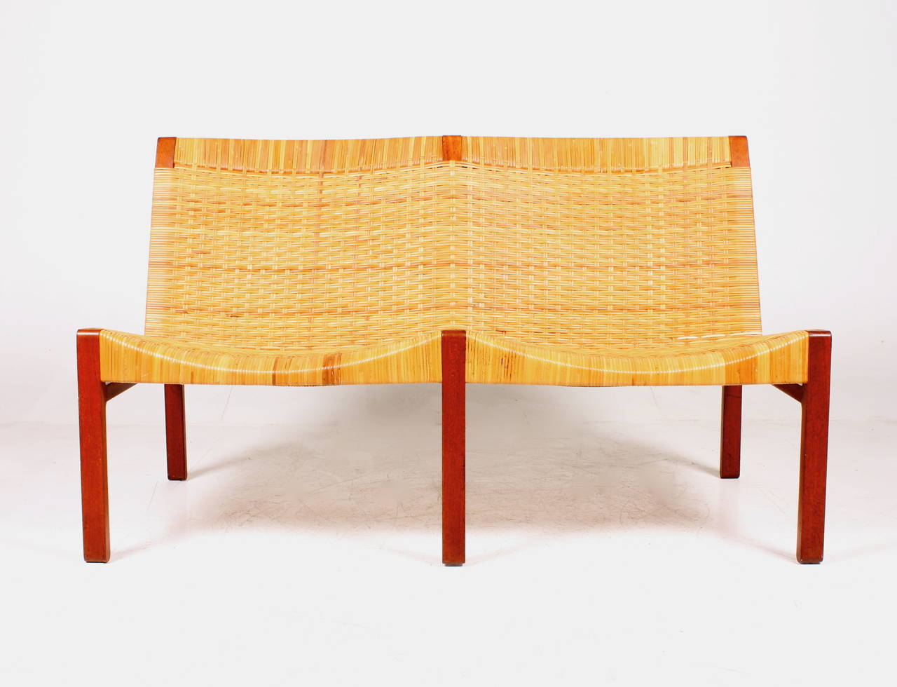 Bench in solid teak and cane designed by Maa. Ejner Larsen and Aksel Bender Madsen, made by Danish cabinetmaker Willy Beck in the 1950s. Great condition.