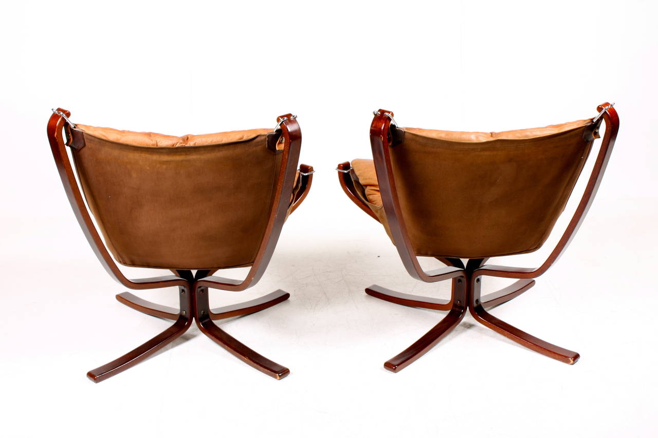 Great looking pair of Falcon chairs, wood frame and patinated leather. Designed by Sigurd Resell in 1968, made by Vatne furniture Norway  Great original condition.