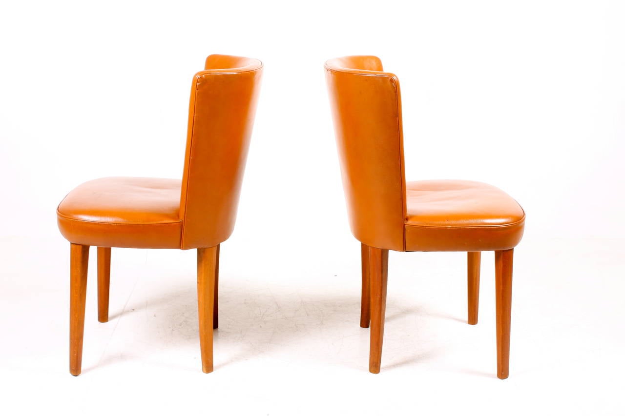 Pair of great looking side chairs in patinated leather designed by Frode Holm for Illums Bolighus Denmark in the 1940s. Great original condition,.