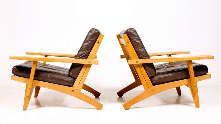 A pair of great looking easy chairs in oak & brown leather - Hans J Wegner Design and edited by Getama Denmark.