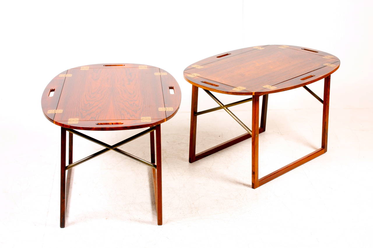 Pair of stunning end or tray tables in rosewood with brass hardware. Designed and made by Svend Langkilde of Denmark in the 1960s. Great original condition.