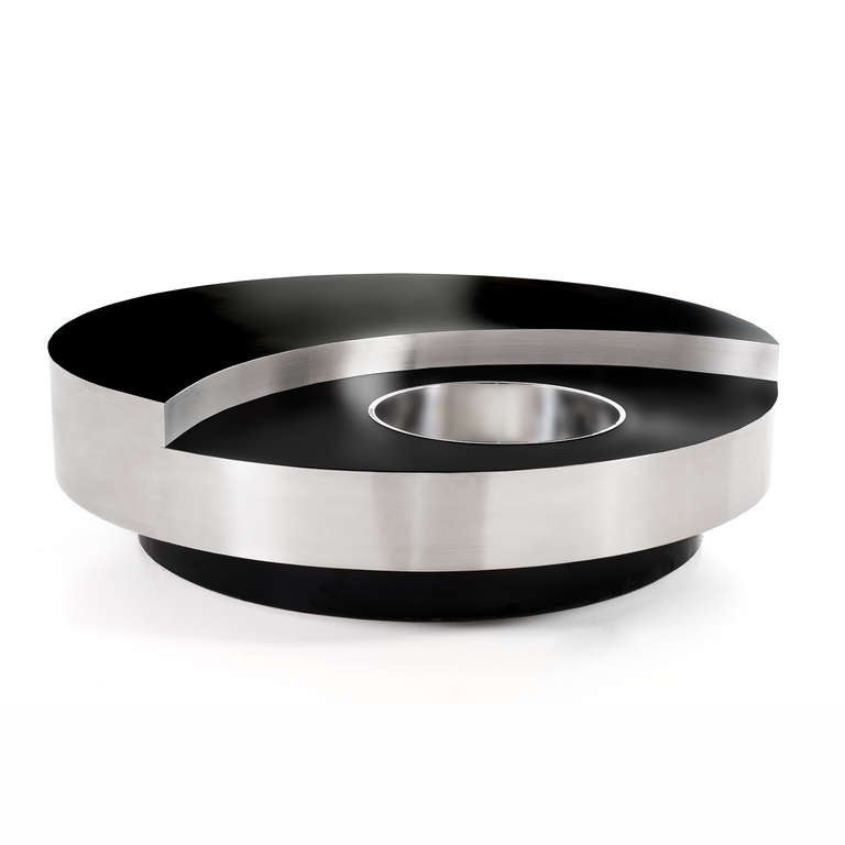Round revolving coffee table designed by Willy Rizzo: the base is covered by black laminate; black lacquered steel on the surface