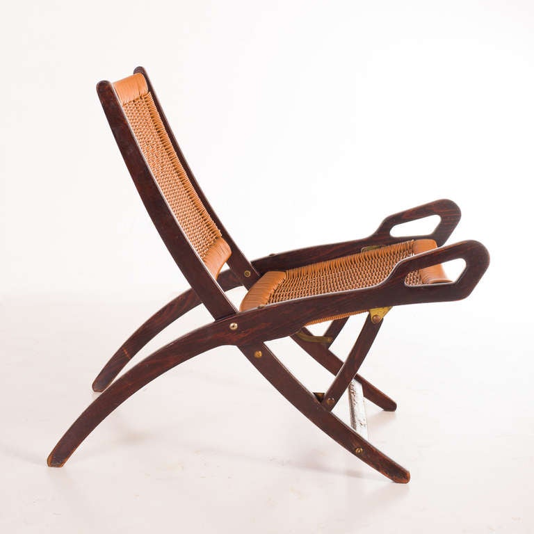 1958 folding lounge chairs by Gio Ponti- F.lli Reguitti ,  wood and wowen plastic.
vintage wood conditions. The plastic is perfect
f.lli Reguitti's label in the back of the chair.