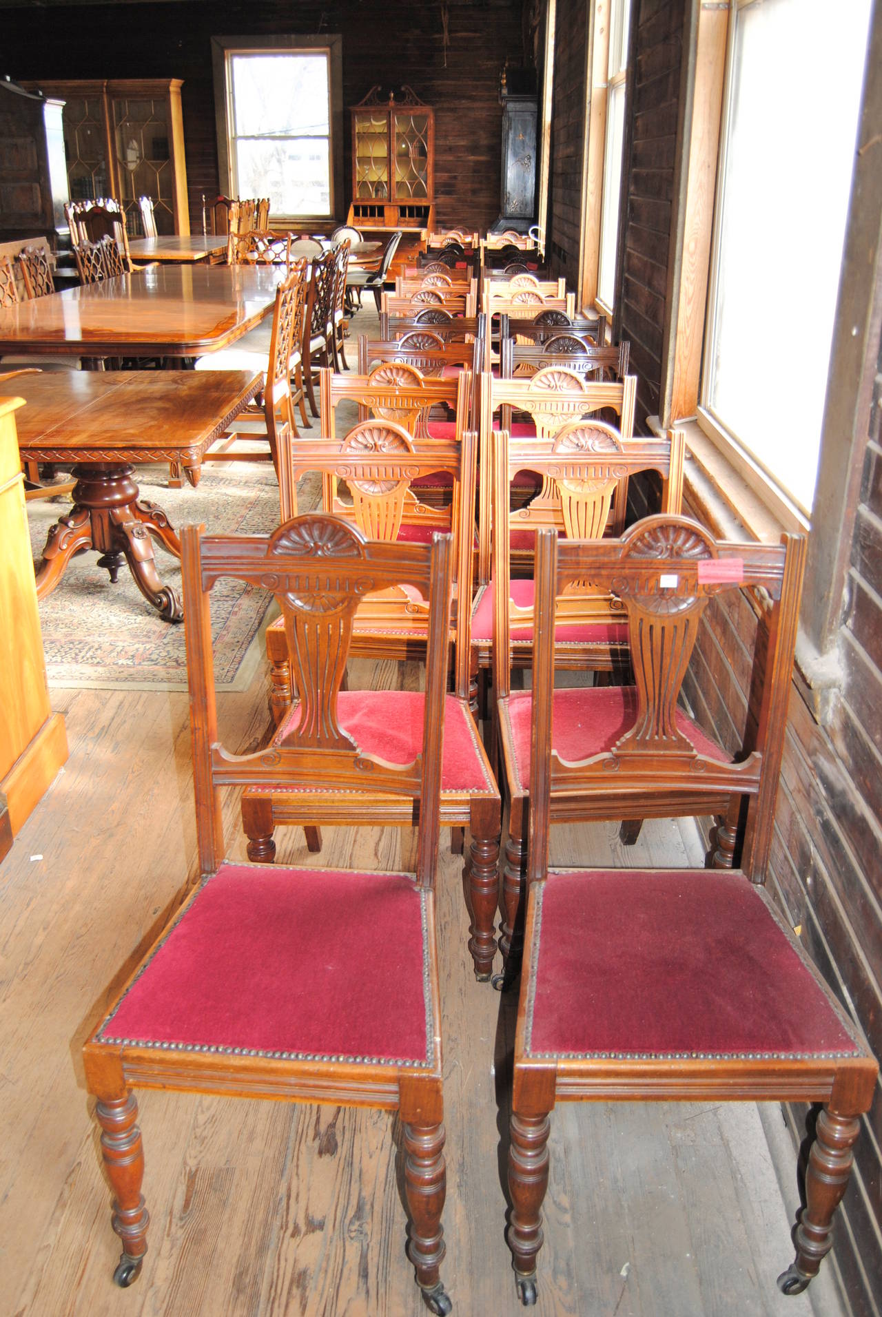 This is a matched set of 18 solid walnut side chairs made in England, circa 1870. The chairs have nicely reeded uprights on the back right and left. The splat in the chair back nicely shaped and is pierced and carved. The seat frame on the front,