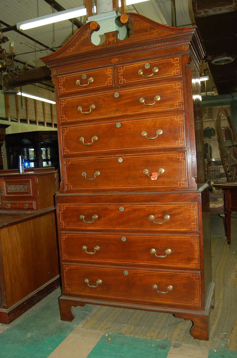 English mahogany chest on chest on bracket feet with string inlays of satinwood on every drawer. Open swan neck pediment to the top with beautiful Inlays. Dental moulding to the top, circa 1790. This is a very beautiful chest on chest.