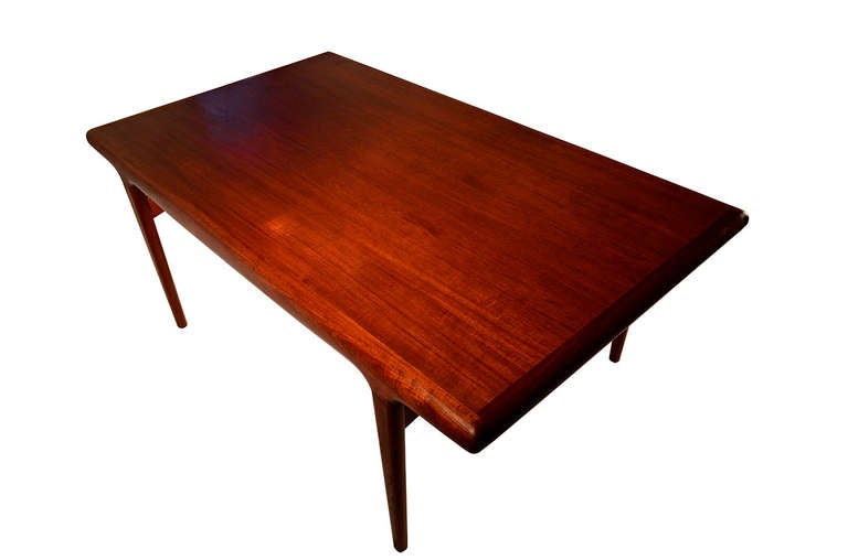 A stunning and rare Organic teak dining Table created by Johannes Andersen. A real master piece of mid century Scandinavian Modernist design. The table was produced by Uldum Mobelfabrik in 1962. The legs and sides of the table are sculpted from