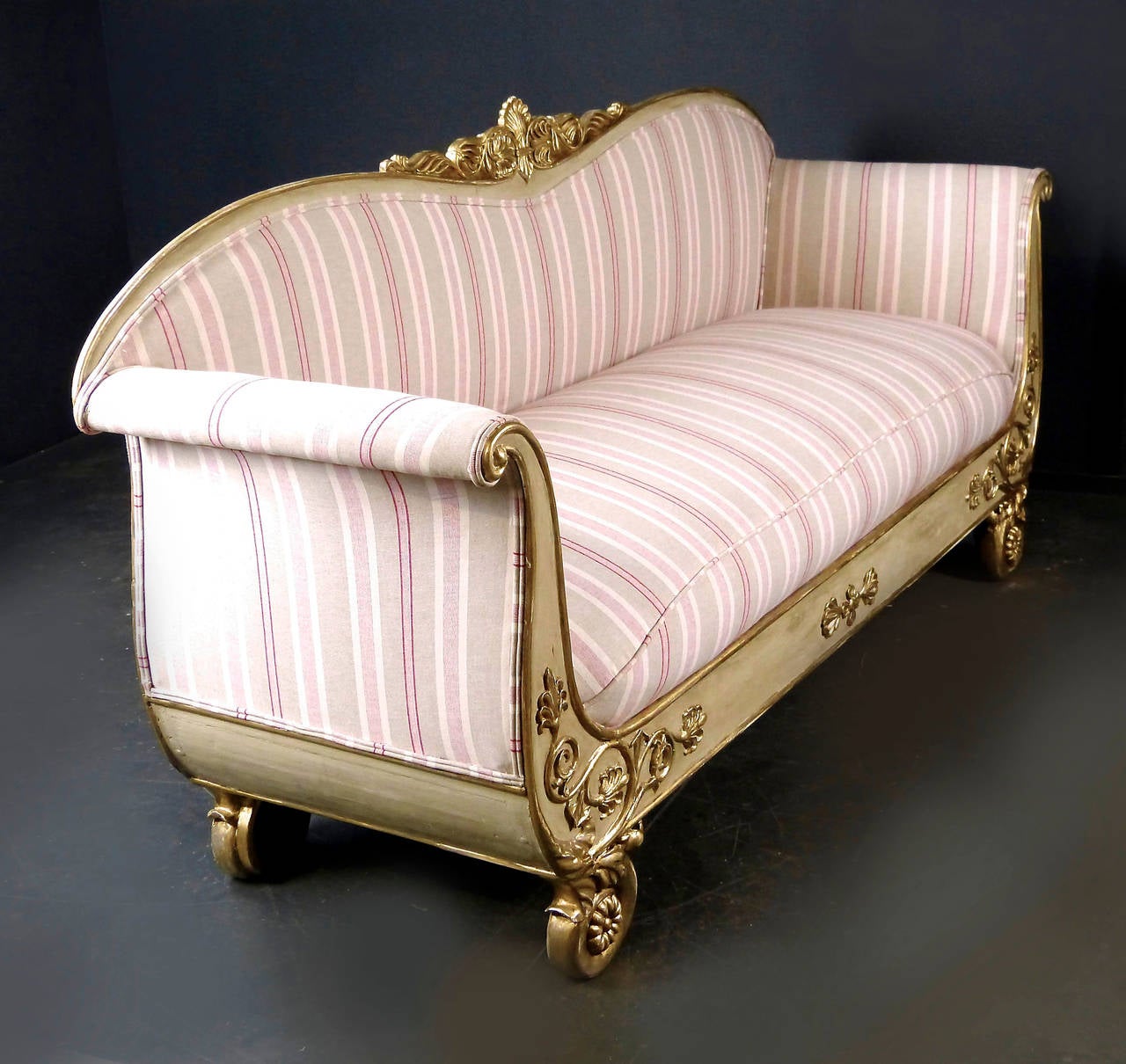 Mid-19th century painted and parcel-gilt sofa of Scandinavian origin, most probably Swedish, with graceful arches on back and sides supported by carved medallion shaped legs. The fine frame carvings are in relief and gilt, slightly time worn and