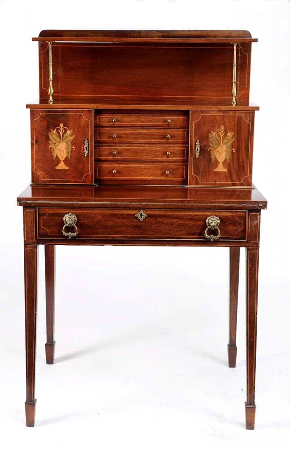 Fine Edwardian ladies desk or bonheur du jour with an unfolding leather lined writing surface supported by a drawer below it which bears two lion head brass pulls. There is fine inlay throughout and fine satinwood and holly marquetry on the front of