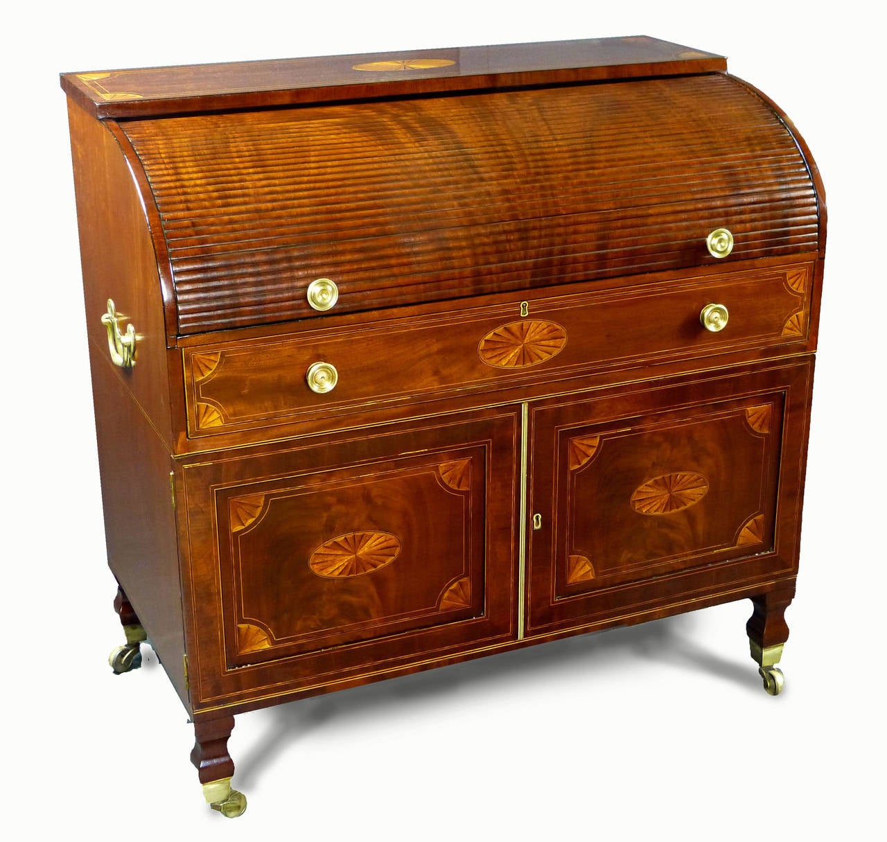 Fine and rare roll-top tambour bureau desk of the George III period, the tambour made out of a single piece of figured mahogany cut into strips and moulded. The entire bureau is constructed of finely figured mahogany decorated with oval paterae,