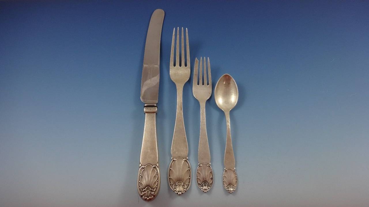 Fabulous handmade Danish 830 silver Mid-Century Modern flatware set by Christian F Heise, circa 1923 - 106 pieces. This pattern has a shell and bead motif with wonderful hand-hammering. This set includes:

11 dinner size knives, 10 1/4