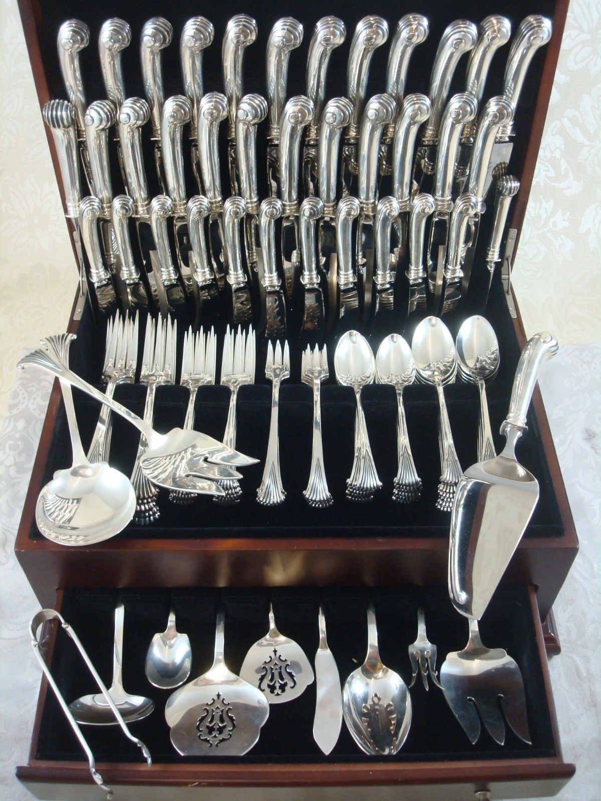 Exquisite Onslow by Tuttle sterling silver massive flatware set, 110 pieces. This pattern is heavy with wonderful pistol-grip handles on the knives. This set includes:

12 knives, 8 3/4