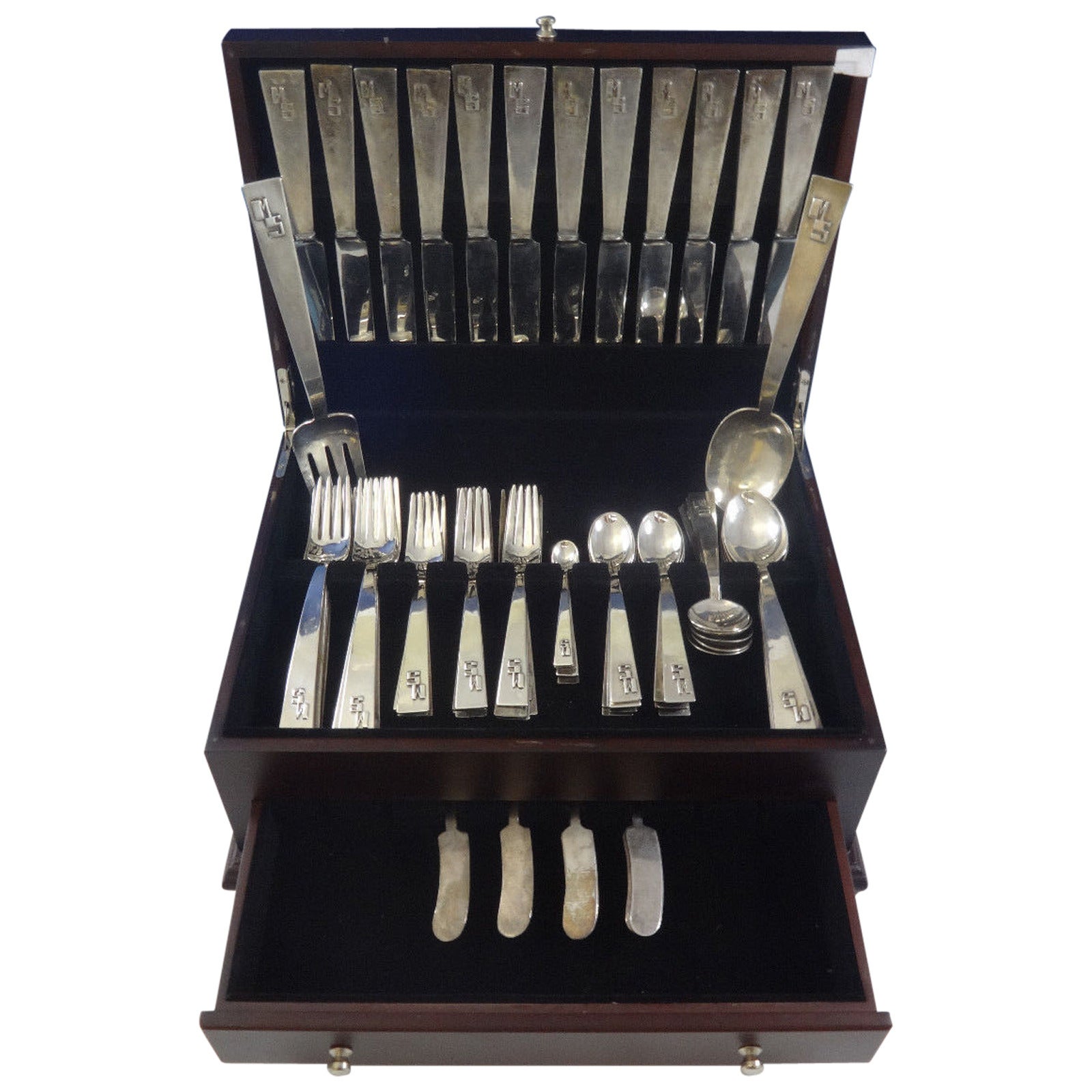 Rare handmade Blok by Maria Regnier sterling silver Arts & Crafts flatware dinner size set, 98 pieces. This set includes:

12 innovative solid handle dinner knives, 9 3/4