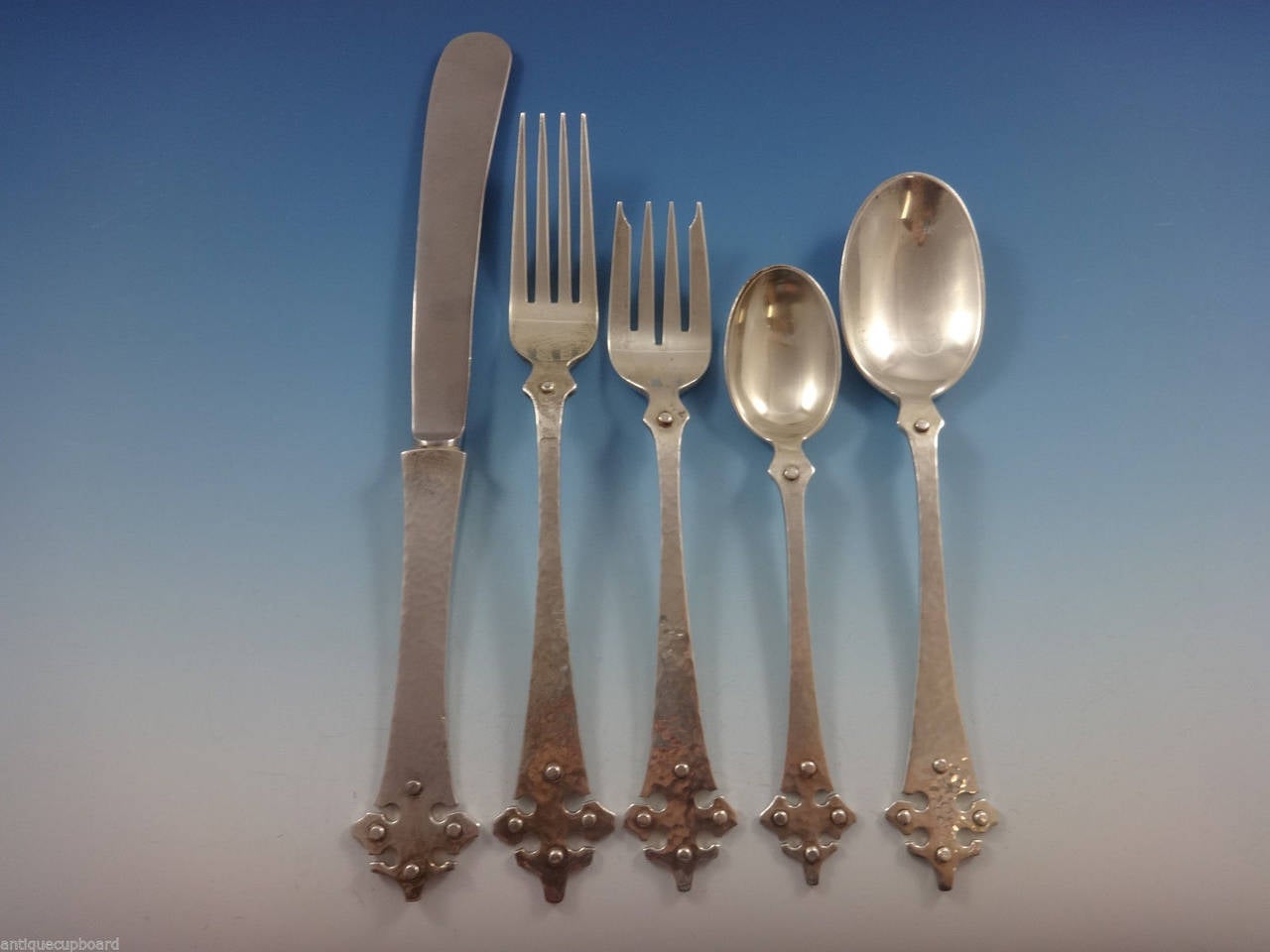 Old Newbury Crafters silver is genuinely handmade and wonderfully heavy, the machine cannot match the quality, durability, look and feel of handmade silver. The subtle hammered finish shows silver at its finest. 

Amazing 41 piece set of Crusader