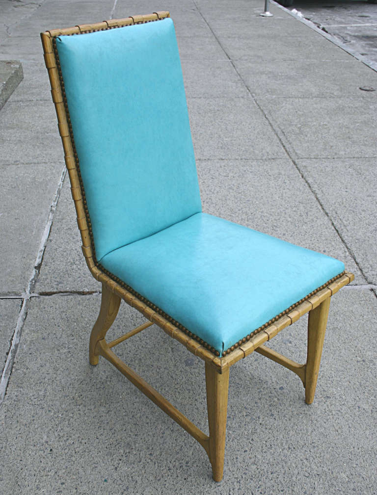 A fun set of four dining or game chairs. Limed oak frames with turquoise blue vinyl upholstery and brass nail head trim. Designed by Harold Schwartz for Romweber in the early 1950's. 