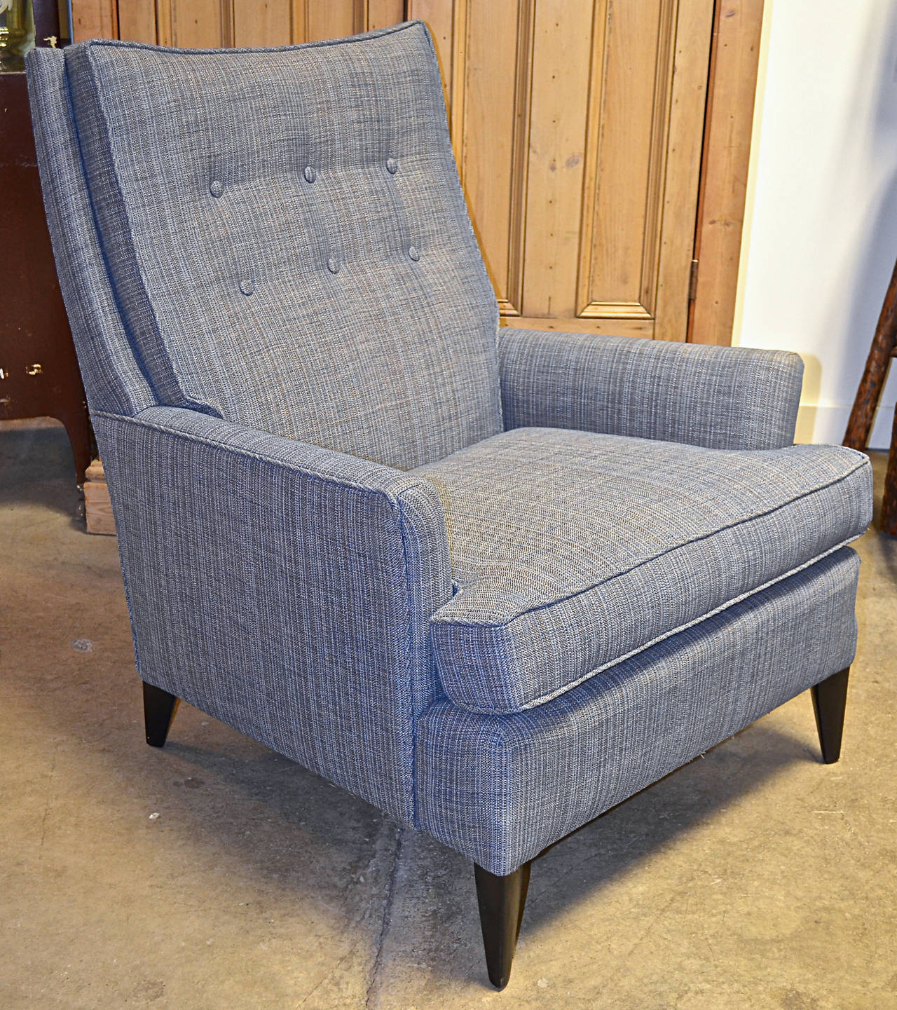 Stylish lines to this high back lounge chair in the style of Wormley. Newly upholstered in shades of blue.