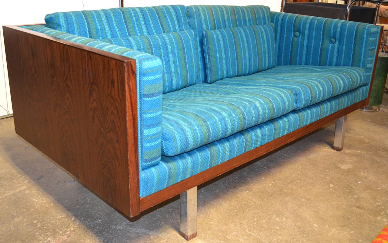 Richly grained wood case loveseat by Milo Baughman. Possibly rosewood frame. Original upholstery. Square chrome tube legs with matching wood caps.
Matching sofa available.