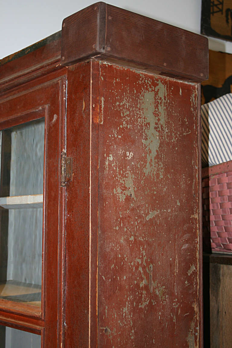 From the Stephanie Lloyd Collection: a wonderful New England country farm house painted cupboard in original barn red paint. Paint has nice craquellure showing through to under color of pale green. A step back with 2 glass doors with original wavy