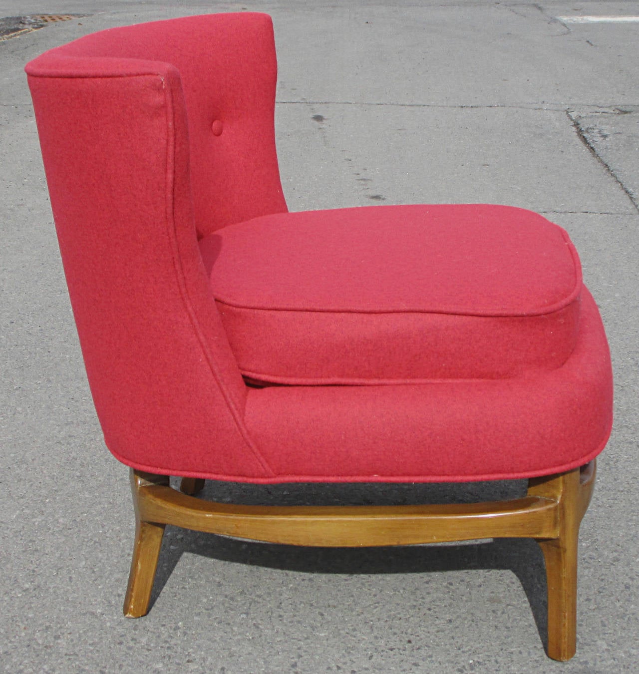 A really sharp looking pair of mid century slipper chairs. Newly reupholstered in a raspberry heather wool felt. Interesting shaped legs with similarly shaped stretcher. Normal age appropriate wear to feat. Old repair to one stretcher section.