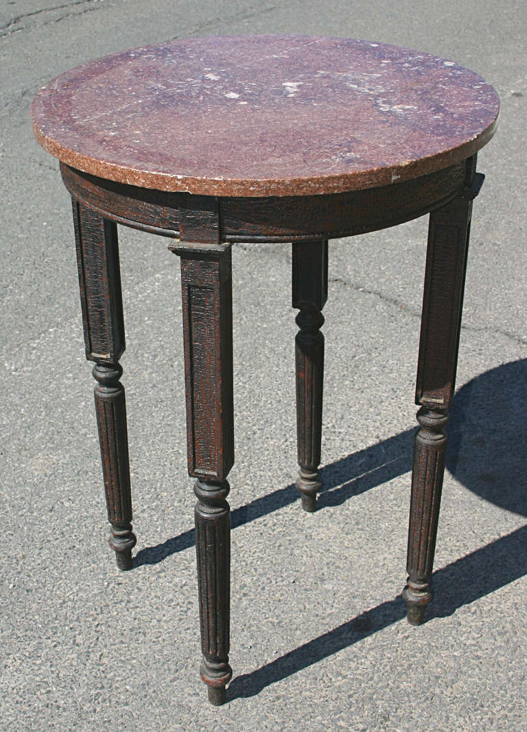 Wonderful pair of circa 1900 marble top tables with old craquellure black paint over red mahogany stain.