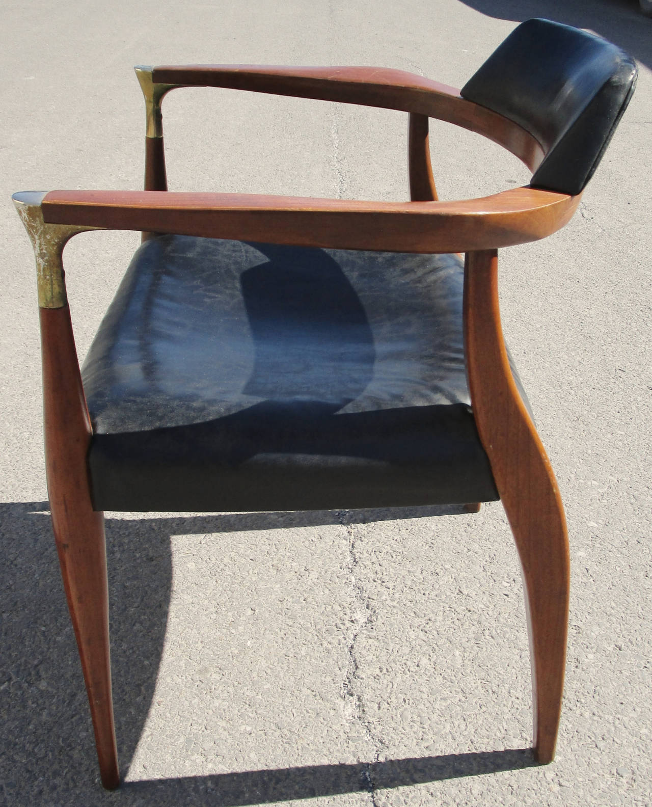 Teak desk chair. Original black vinyl. Wear to metal plating.