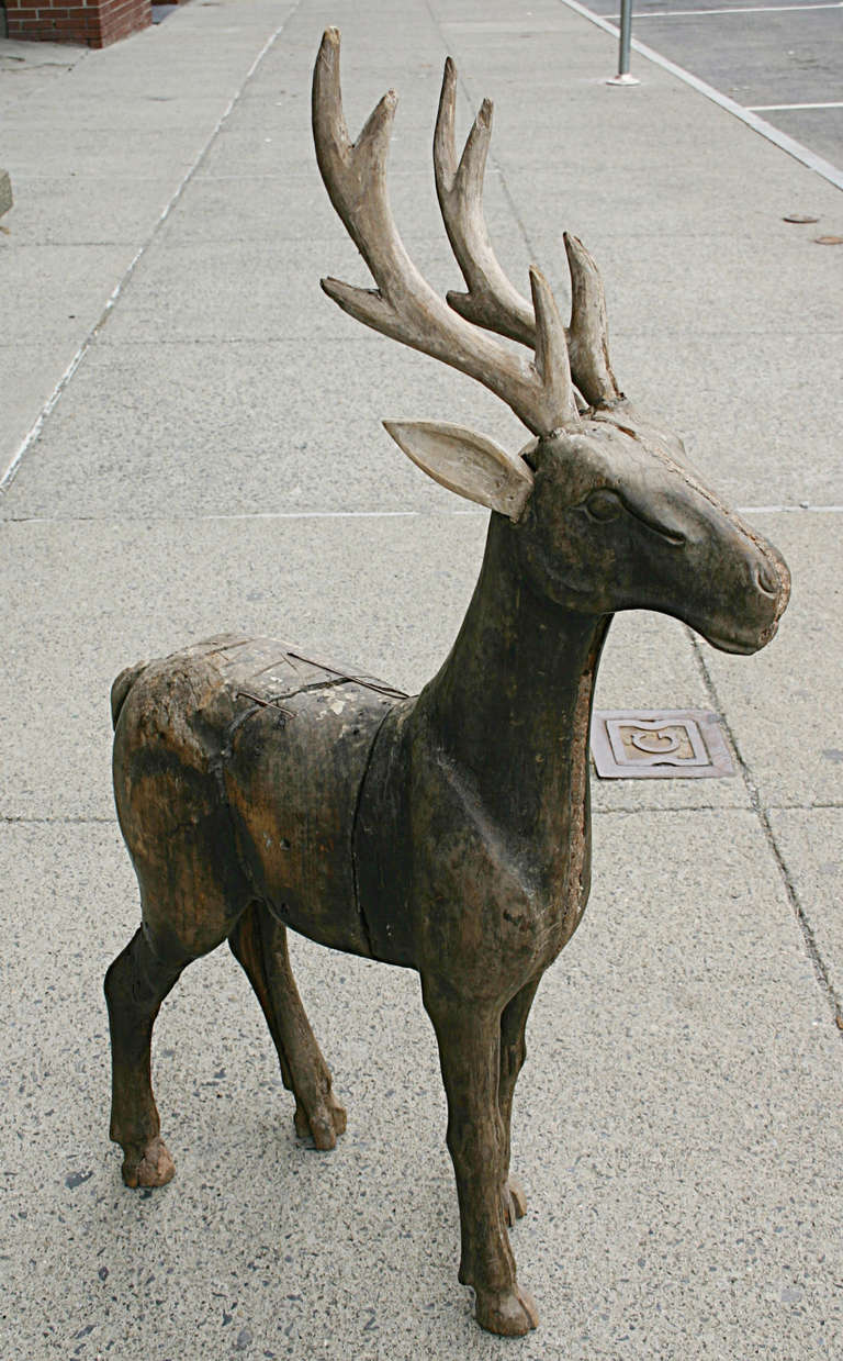 Carved wooden deer form with detachable antlers and ears.  19th century. Well worn with good patina minor losses to hooves. Older repairs to ears.