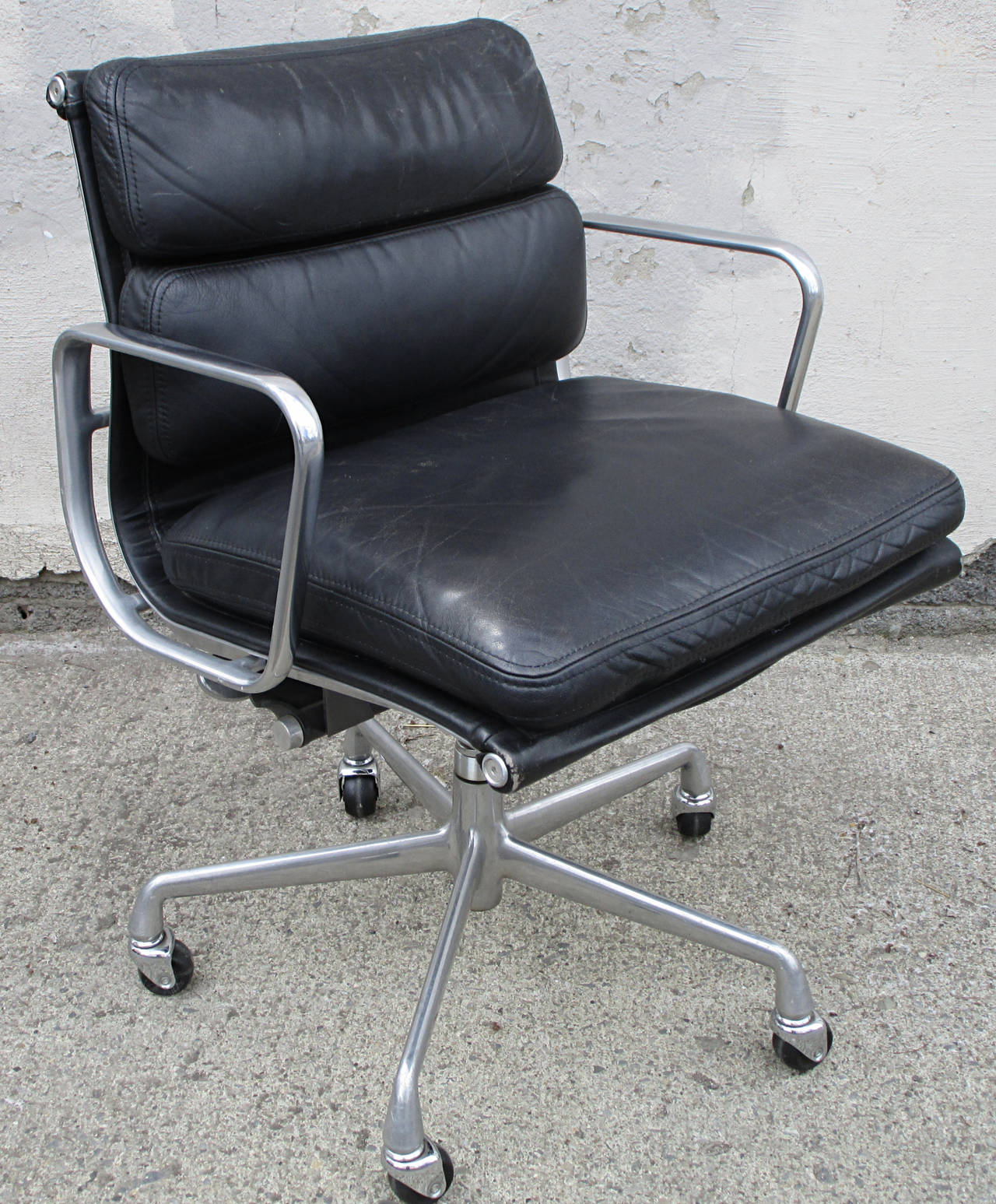 The classic Eames design from 1969 is one of the most iconic task chairs ever created. This model was produced in the late 1980s. The black leather has a rich warm patina and soft hand. Adjustable seat height and tilt. The steel and aluminum are