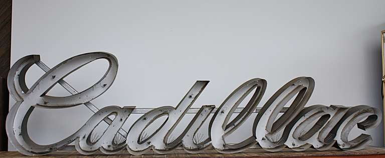 Large Cadillac old neon sign frame. No neon. Aluminum letters with added aluminum hanging bar added to back. Still has original wire 