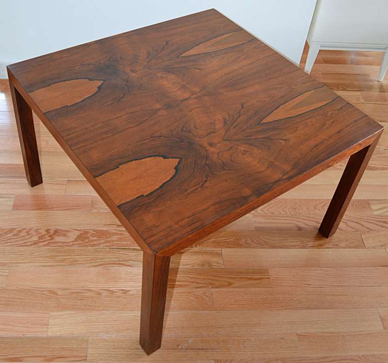 A heavily figured book matched square table. Parson's style, square legs support a beautiful rosewood top.